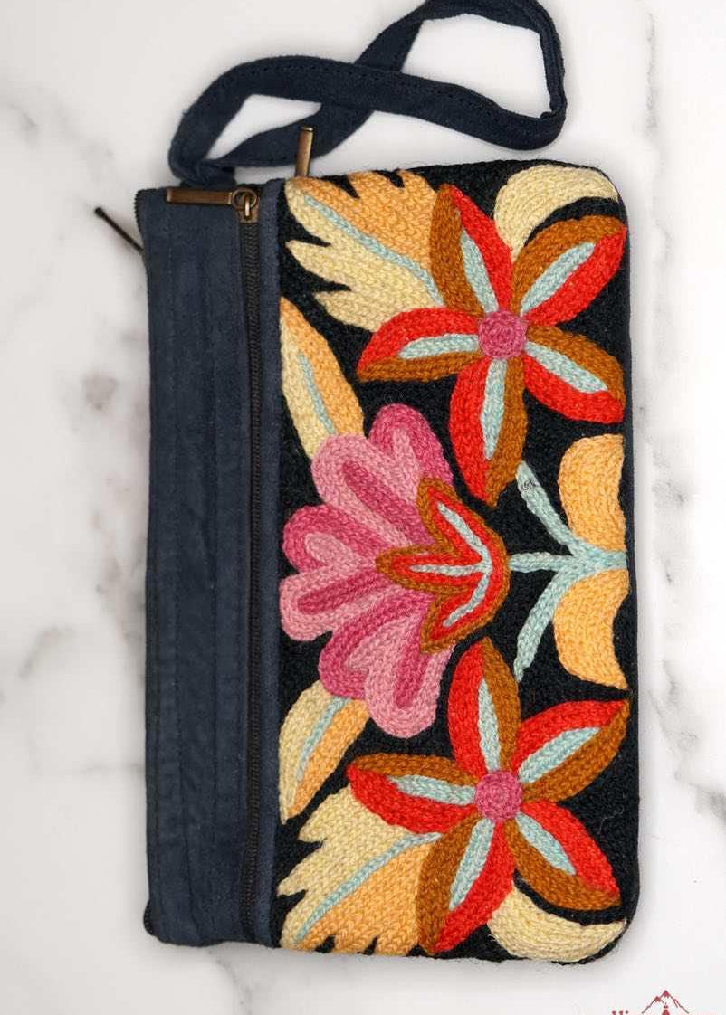 A stylish yet convenient hand woven wristlet purse with beautiful floral pattern, It has a secure zip top closure and two extra compartments for your everyday essentials making it easy to travel simple and light.