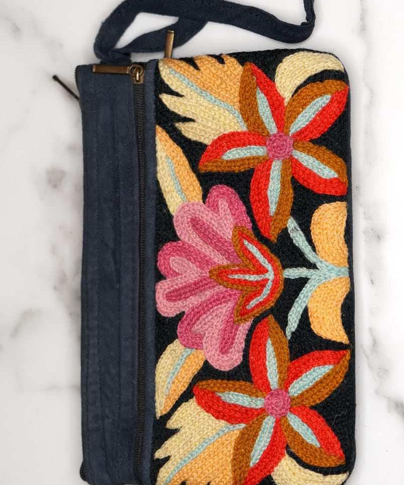 A stylish yet convenient hand woven wristlet purse with beautiful floral pattern, It has a secure zip top closure and two extra compartments for your everyday essentials making it easy to travel simple and light.