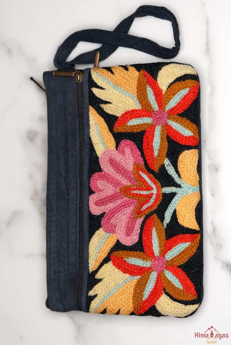 A stylish yet convenient hand woven wristlet purse with beautiful floral pattern, It has a secure zip top closure and two extra compartments for your everyday essentials making it easy to travel simple and light.