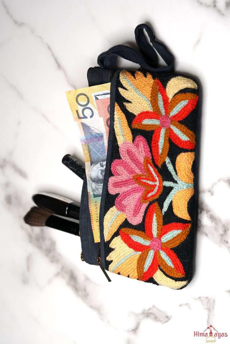 A stylish yet convenient hand woven wristlet purse with beautiful floral pattern, It has a secure zip top closure and two extra compartments for your everyday essentials making it easy to travel simple and light.