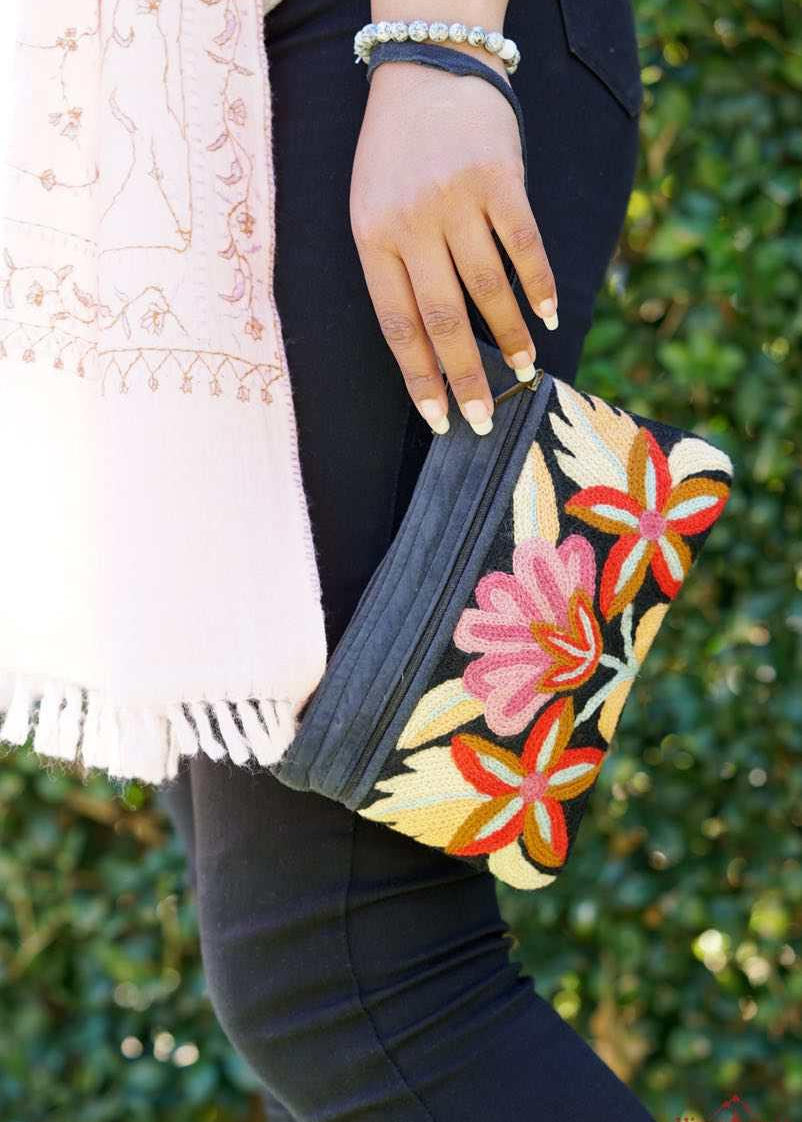 A stylish yet convenient hand woven wristlet purse with beautiful floral pattern, It has a secure zip top closure and two extra compartments for your everyday essentials making it easy to travel simple and light.