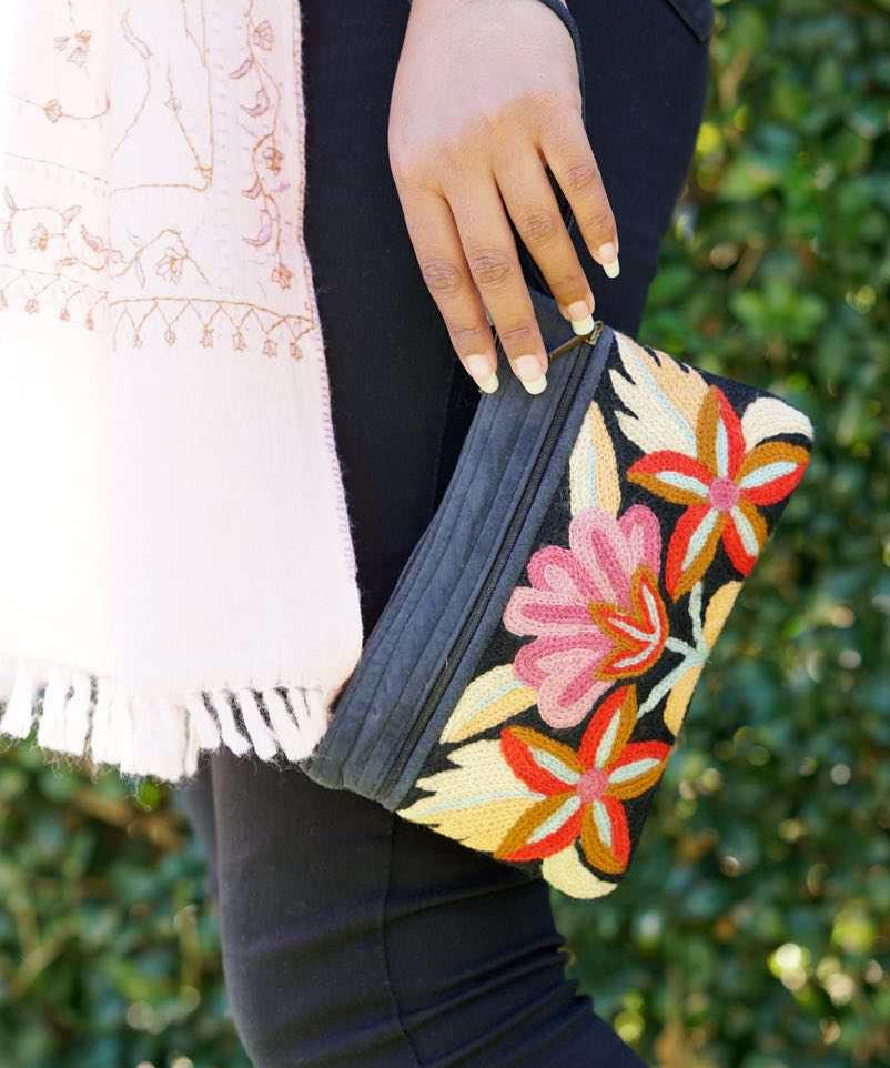 A stylish yet convenient hand woven wristlet purse with beautiful floral pattern, It has a secure zip top closure and two extra compartments for your everyday essentials making it easy to travel simple and light.