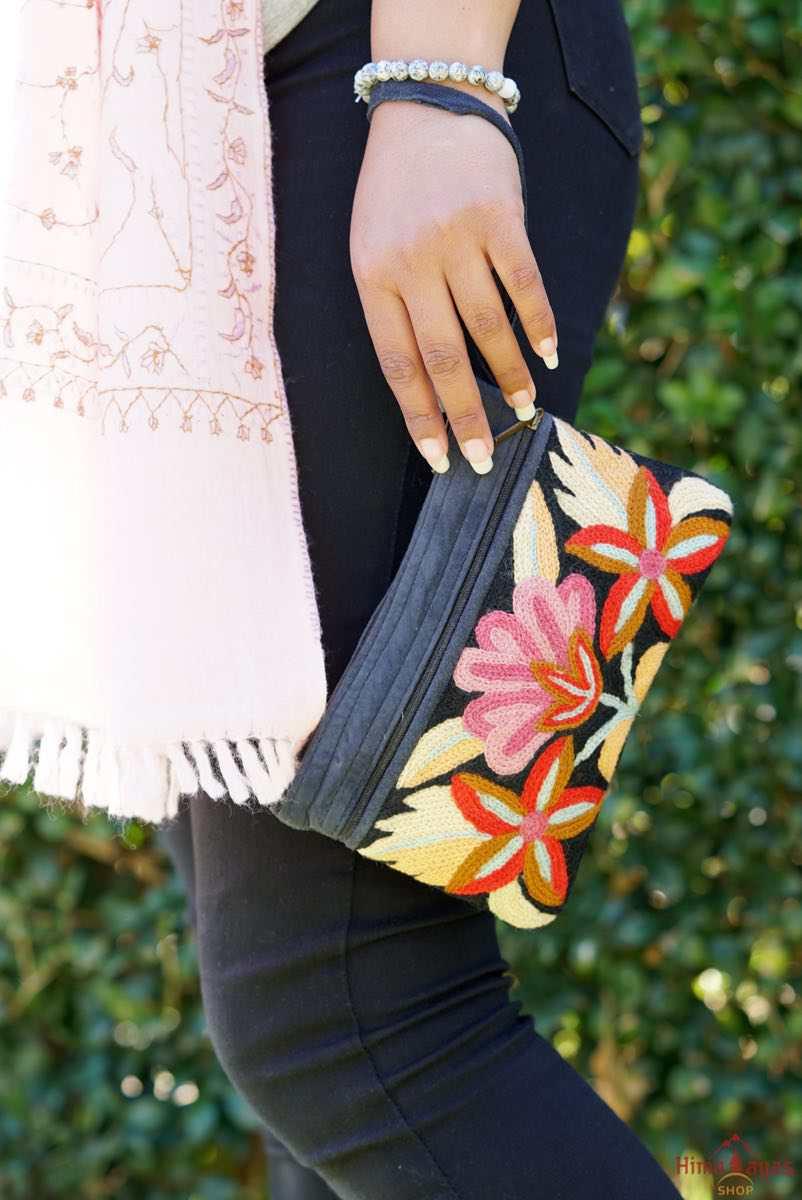 A stylish yet convenient hand woven wristlet purse with beautiful floral pattern, It has a secure zip top closure and two extra compartments for your everyday essentials making it easy to travel simple and light.