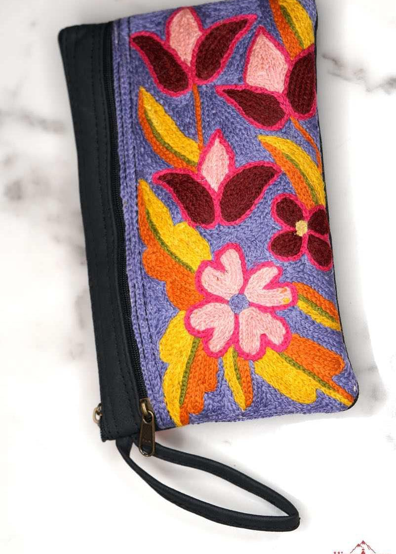 Beautiful flower pattern woman's purse that features a wristlet and secure zip top closure.