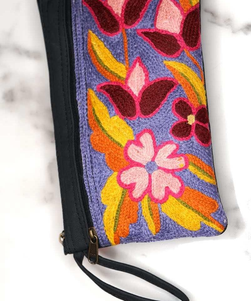 Beautiful flower pattern woman's purse that features a wristlet and secure zip top closure.