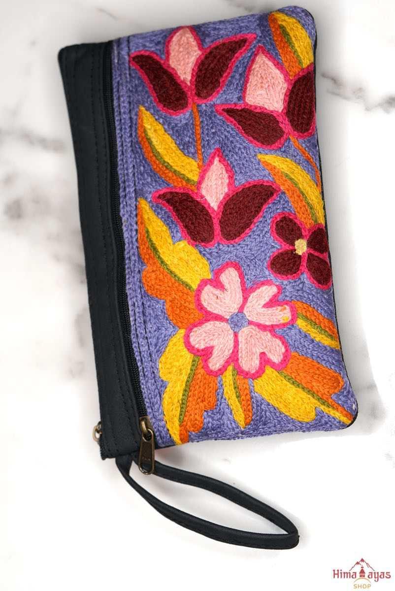 Beautiful flower pattern woman's purse that features a wristlet and secure zip top closure.