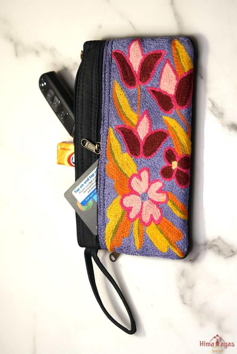 Beautiful flower pattern woman's purse that features a wristlet and secure zip top closure.