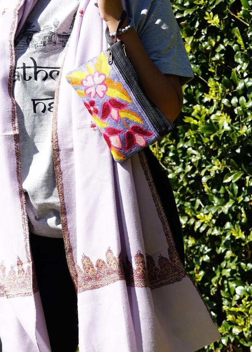 Beautiful flower pattern woman's purse that features a wristlet and secure zip top closure.