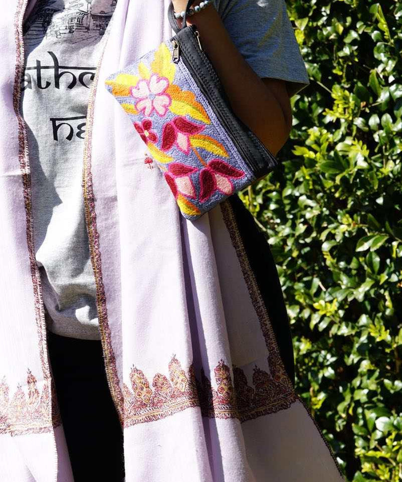 Beautiful flower pattern woman's purse that features a wristlet and secure zip top closure.