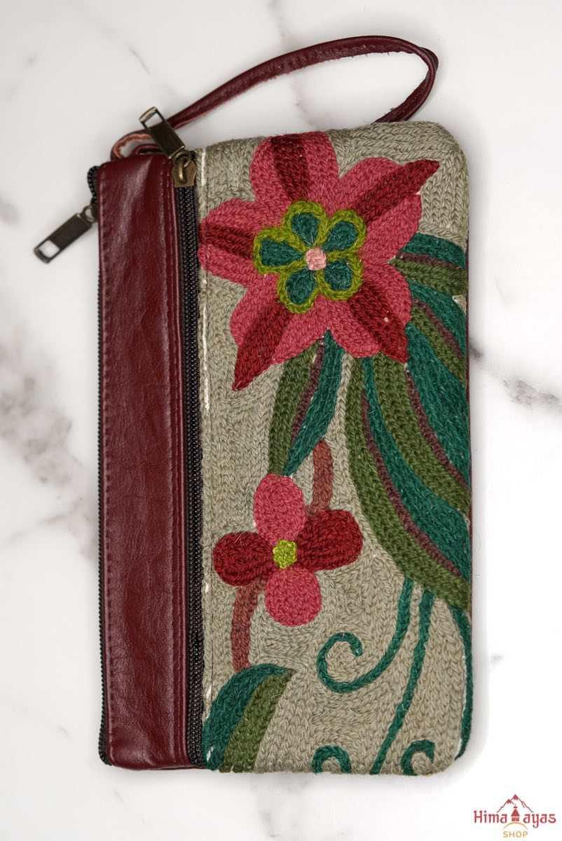  The wallet is crafted with top quality hand-woven fabric, with PU leather at the back. It features a wristlet and a secure zip top closure , two extra compartments both at front and back to carry all your everyday use essentials.