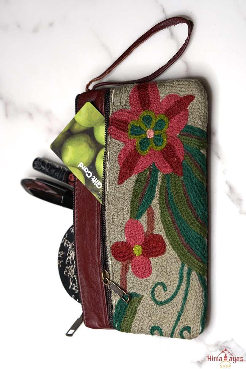  The wallet is crafted with top quality hand-woven fabric, with PU leather at the back. It features a wristlet and a secure zip top closure , two extra compartments both at front and back to carry all your everyday use essentials.