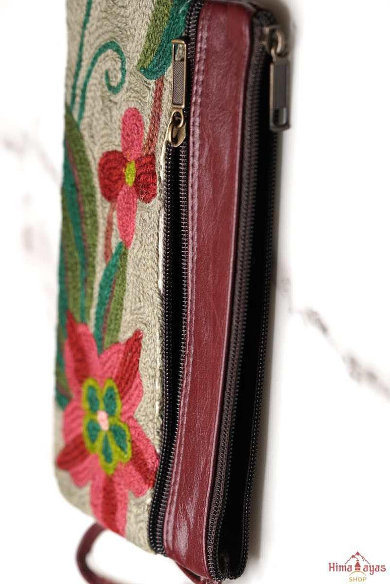  The wallet is crafted with top quality hand-woven fabric, with PU leather at the back. It features a wristlet and a secure zip top closure , two extra compartments both at front and back to carry all your everyday use essentials.