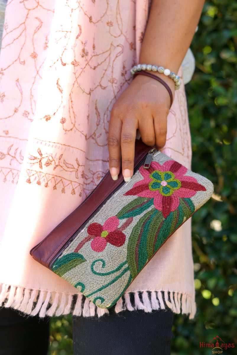  The wallet is crafted with top quality hand-woven fabric, with PU leather at the back. It features a wristlet and a secure zip top closure , two extra compartments both at front and back to carry all your everyday use essentials.