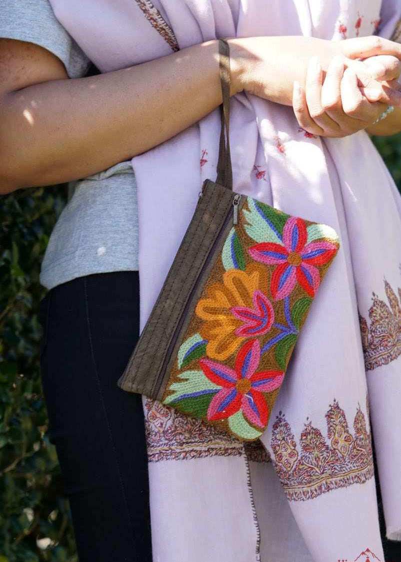 A stylish yet convenient hand woven wristlet purse with beautiful floral pattern, It has a secure zip top closure and two extra compartments for your everyday essentials making it easy to travel simple and light.