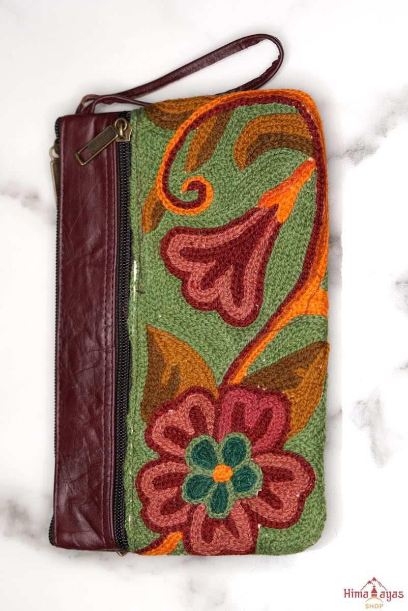  The wallet is crafted with top quality hand-woven fabric, with PU leather at the back. It features a wristlet and a secure zip top closure , two extra compartments both at front and back to carry all your everyday use essentials.