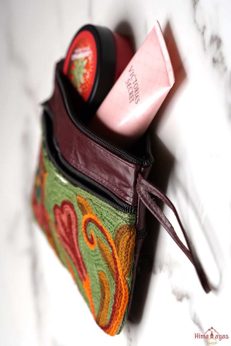  The wallet is crafted with top quality hand-woven fabric, with PU leather at the back. It features a wristlet and a secure zip top closure , two extra compartments both at front and back to carry all your everyday use essentials.