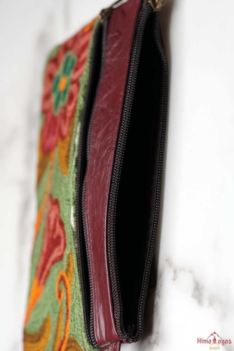  The wallet is crafted with top quality hand-woven fabric, with PU leather at the back. It features a wristlet and a secure zip top closure , two extra compartments both at front and back to carry all your everyday use essentials.