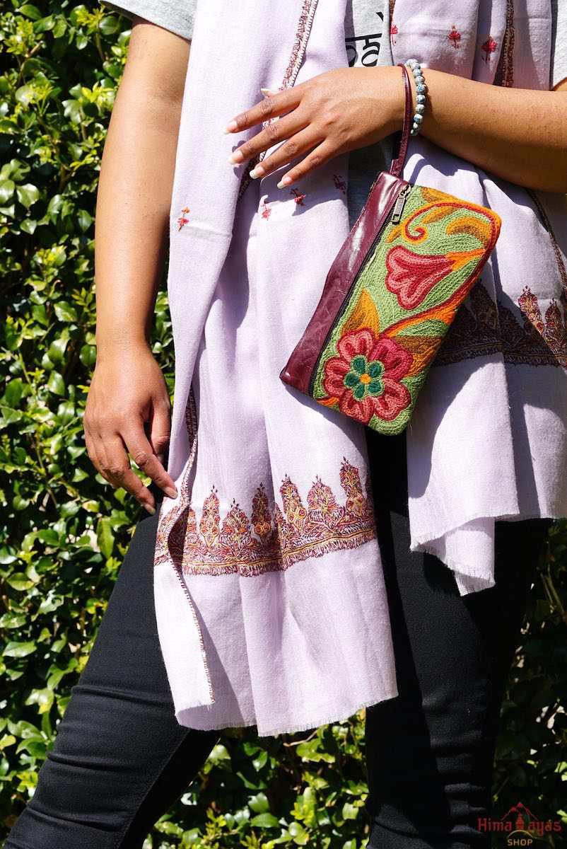  The wallet is crafted with top quality hand-woven fabric, with PU leather at the back. It features a wristlet and a secure zip top closure , two extra compartments both at front and back to carry all your everyday use essentials.