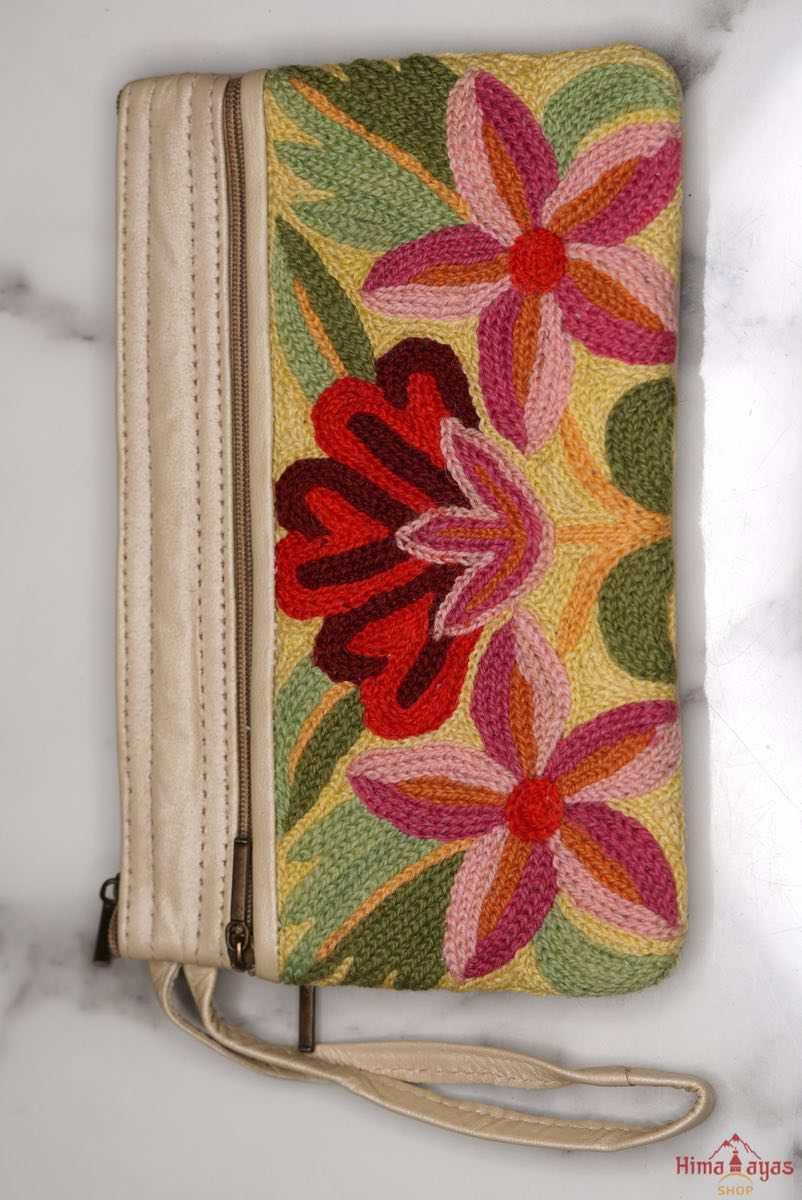 A stylish yet convenient hand woven wristlet purse with beautiful floral pattern, It has a secure zip top closure and two extra compartments for your everyday essentials making it easy to travel simple and light.