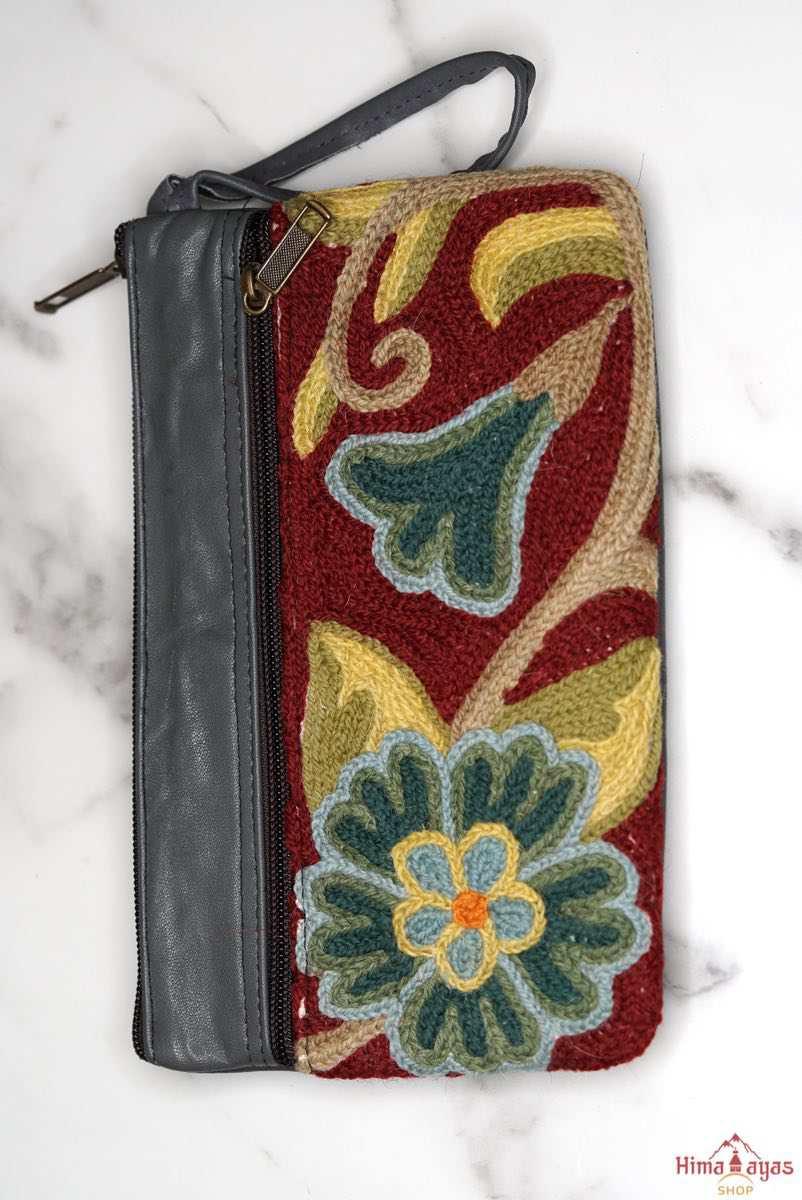  The wallet is crafted with top quality hand-woven fabric, with PU leather at the back. It features a wristlet and a secure zip top closure , two extra compartments both at front and back to carry all your everyday use essentials.