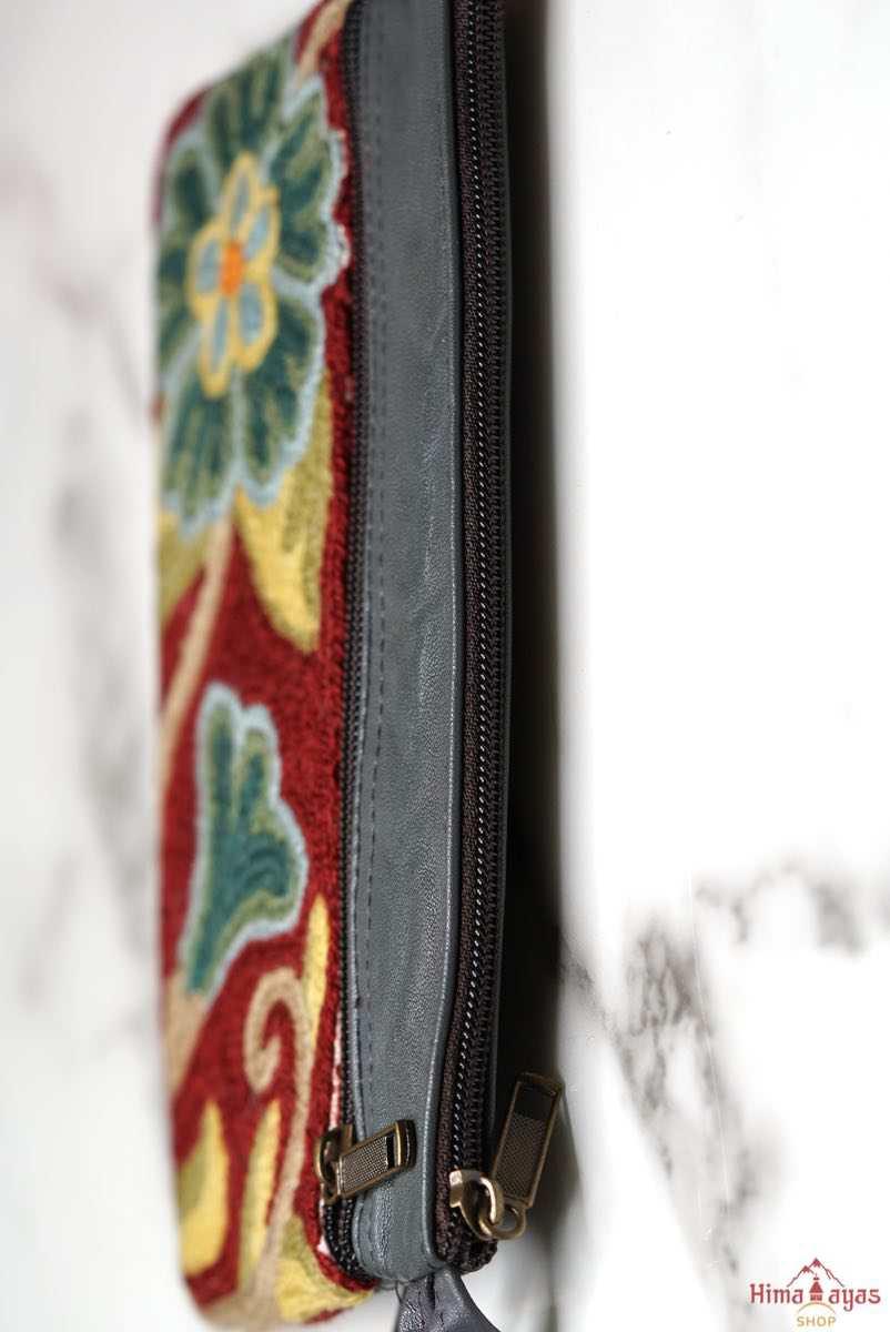  The wallet is crafted with top quality hand-woven fabric, with PU leather at the back. It features a wristlet and a secure zip top closure , two extra compartments both at front and back to carry all your everyday use essentials.