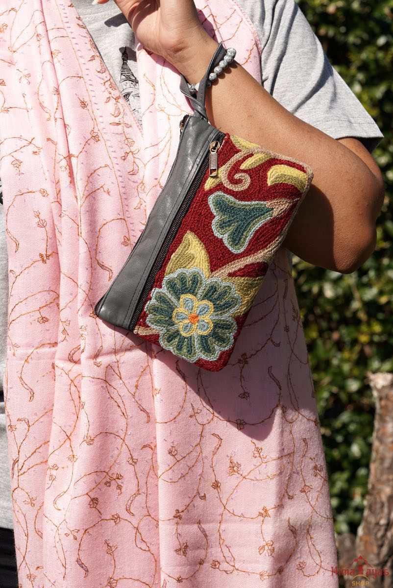  The wallet is crafted with top quality hand-woven fabric, with PU leather at the back. It features a wristlet and a secure zip top closure , two extra compartments both at front and back to carry all your everyday use essentials.