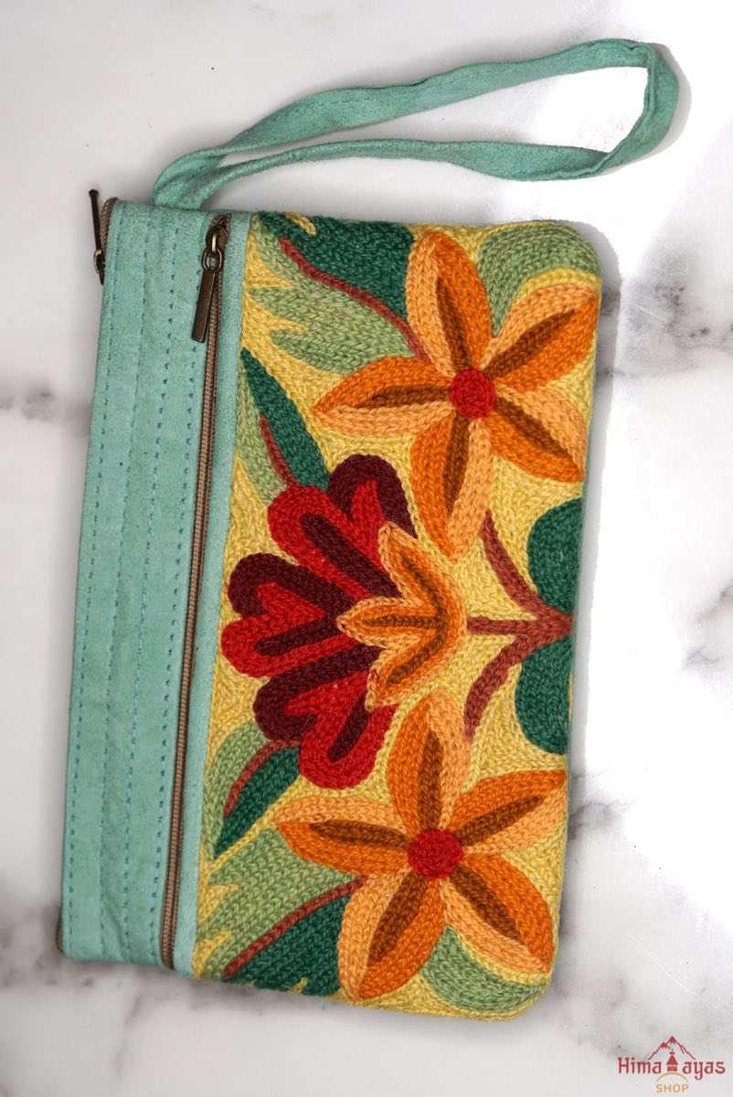A stylish yet convenient hand woven wristlet purse with beautiful floral pattern, It has a secure zip top closure and two extra compartments for your everyday essentials making it easy to travel simple and light.