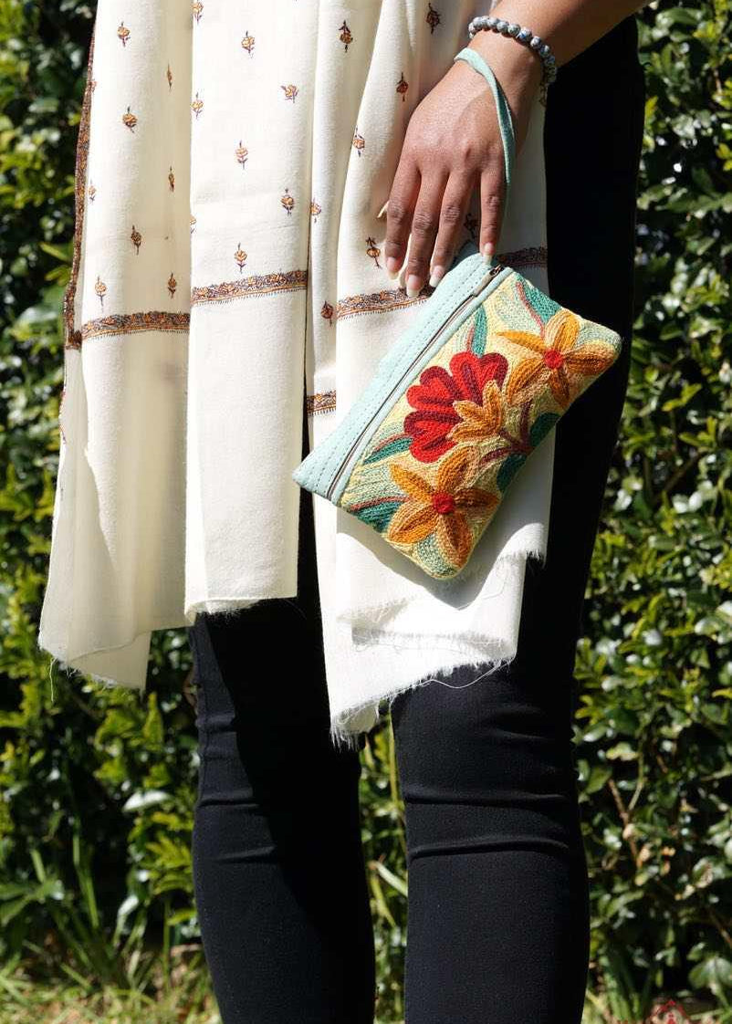 A stylish yet convenient hand woven wristlet purse with beautiful floral pattern, It has a secure zip top closure and two extra compartments for your everyday essentials making it easy to travel simple and light.