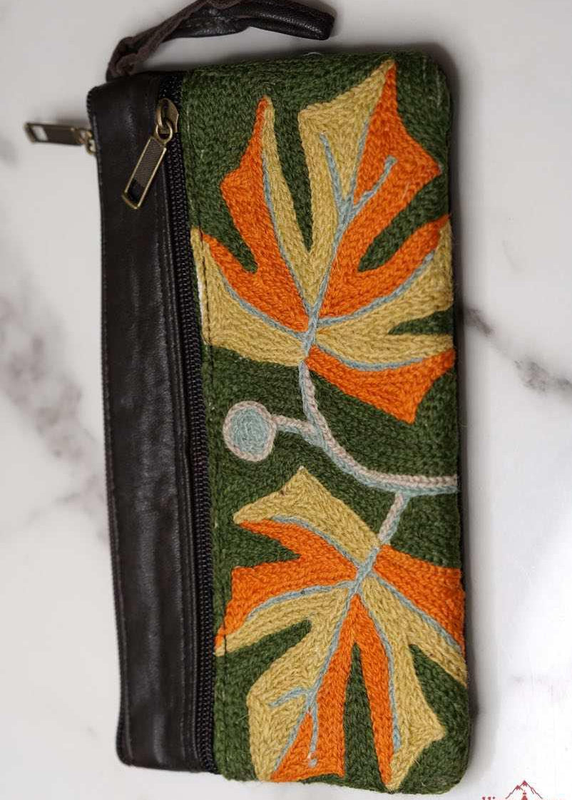 A beautifully hand-embroidered purse with a wristlet and a secure zip top closure. Perfect gift for your loved ones!