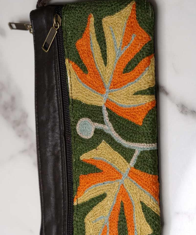A beautifully hand-embroidered purse with a wristlet and a secure zip top closure. Perfect gift for your loved ones!