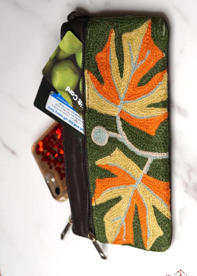 A beautifully hand-embroidered purse with a wristlet and a secure zip top closure. Perfect gift for your loved ones!