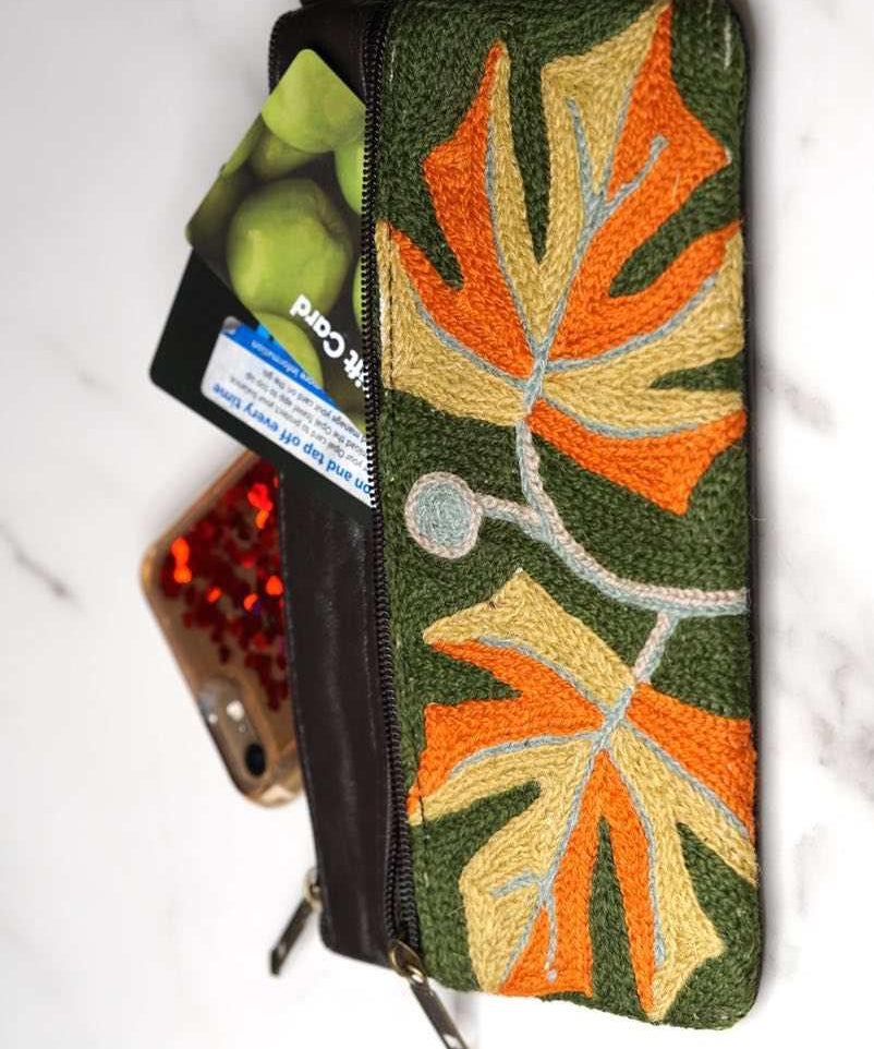 A beautifully hand-embroidered purse with a wristlet and a secure zip top closure. Perfect gift for your loved ones!