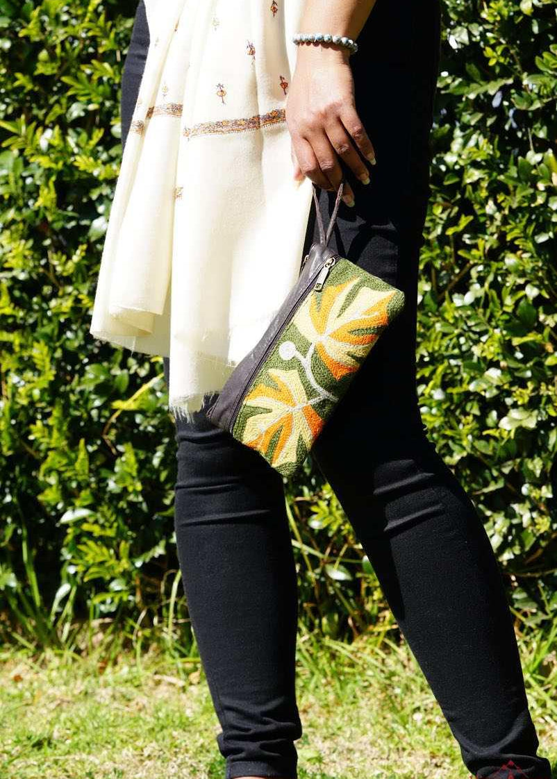 A beautifully hand-embroidered purse with a wristlet and a secure zip top closure. Perfect gift for your loved ones!