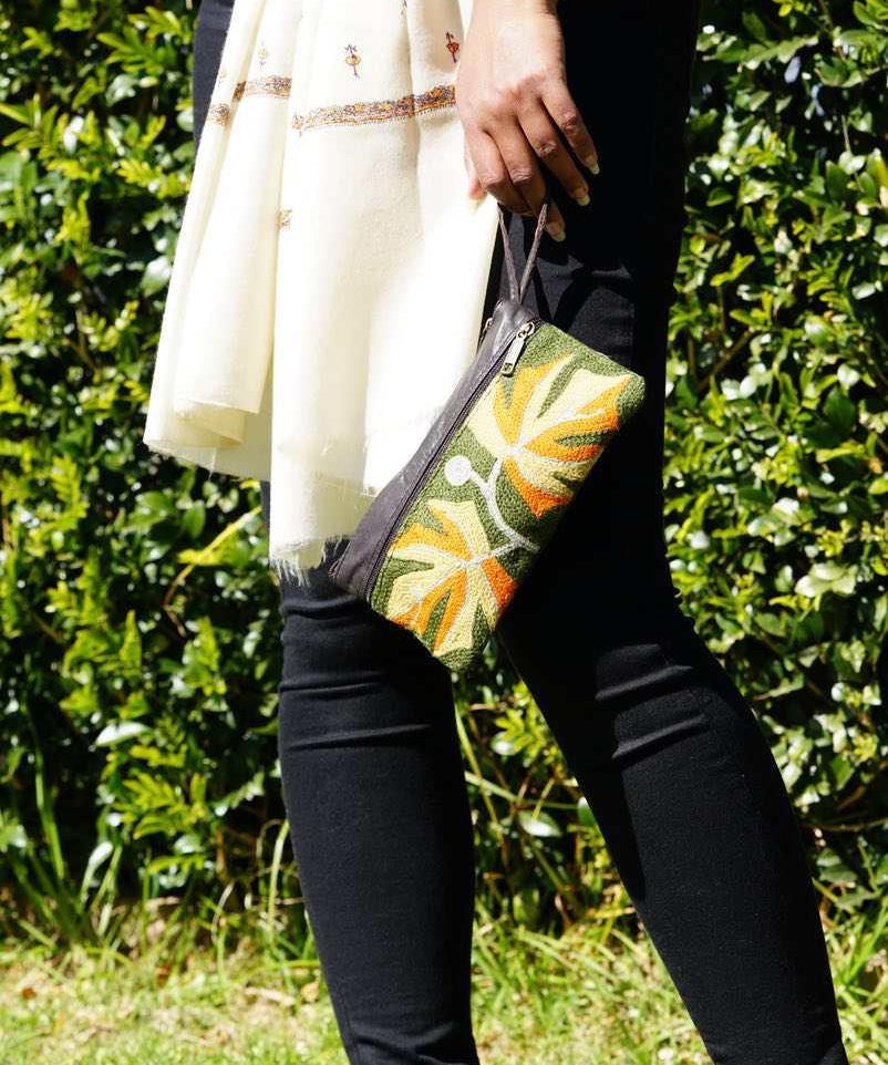 A beautifully hand-embroidered purse with a wristlet and a secure zip top closure. Perfect gift for your loved ones!