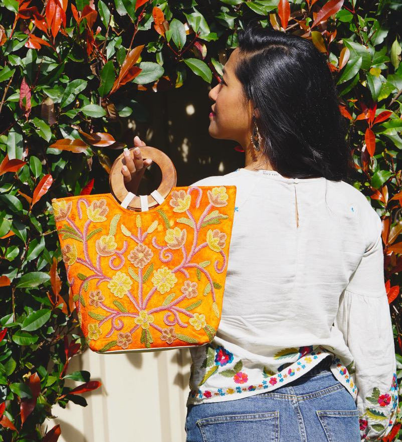 A stylish women's tote bag with floral pattern, crafted ethically from Himalayas.