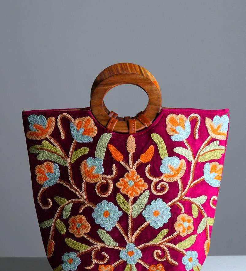 Beautiful hand embroidered tote bag with bright and multi-colour embroidered floral patterns.
