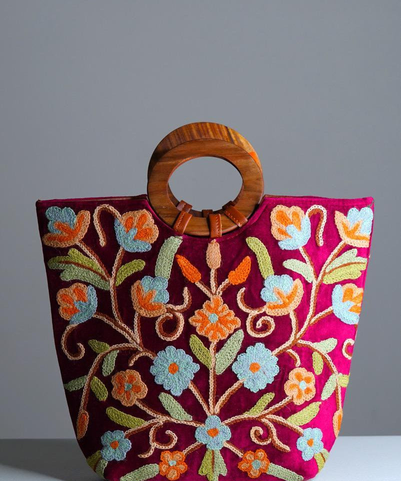 Beautiful hand embroidered tote bag with bright and multi-colour embroidered floral patterns.