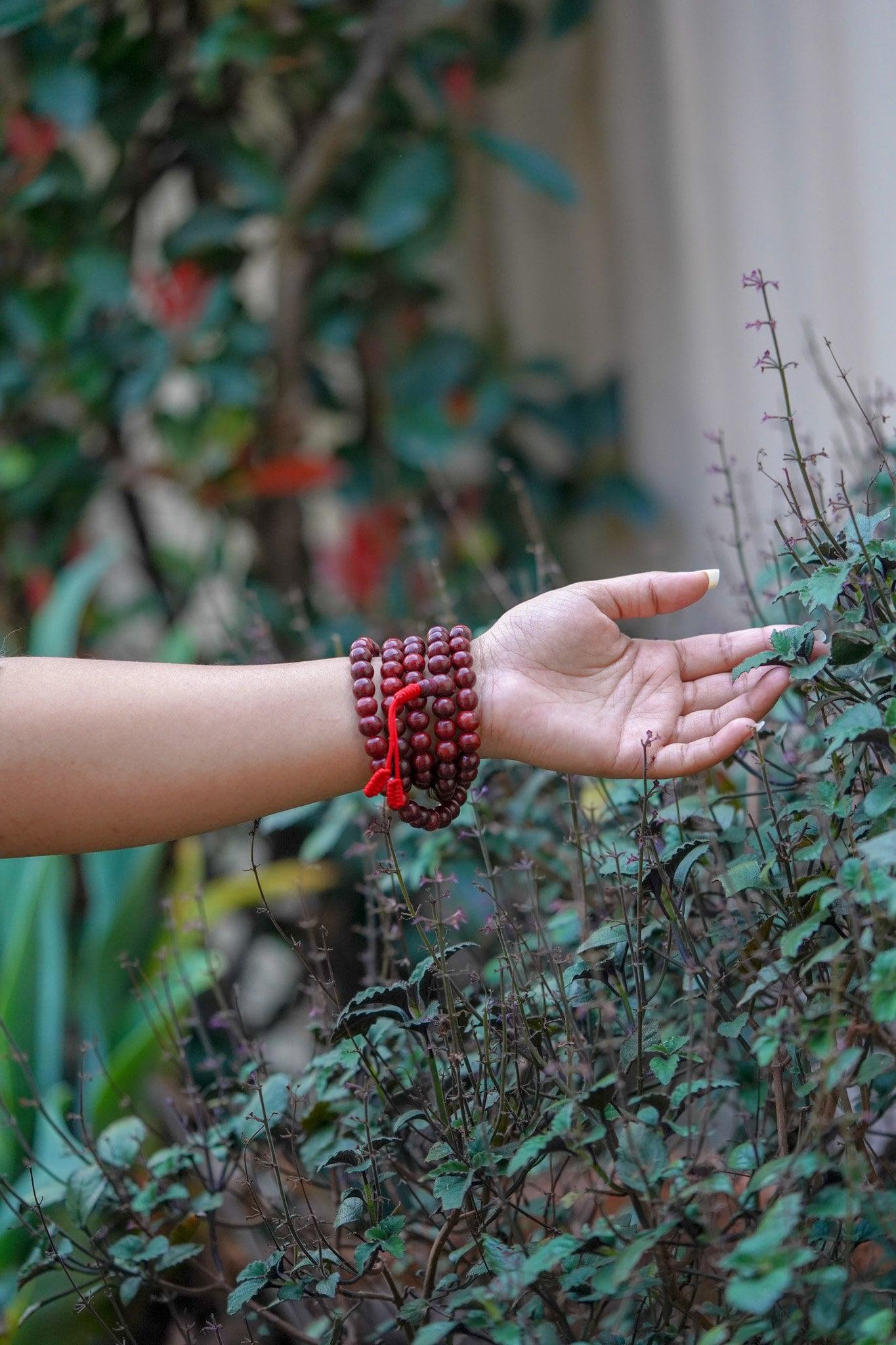 Rosewood Mala being worn around wrist 