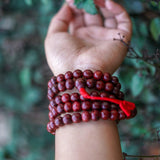 Rosewood Mala being worn around wrist 