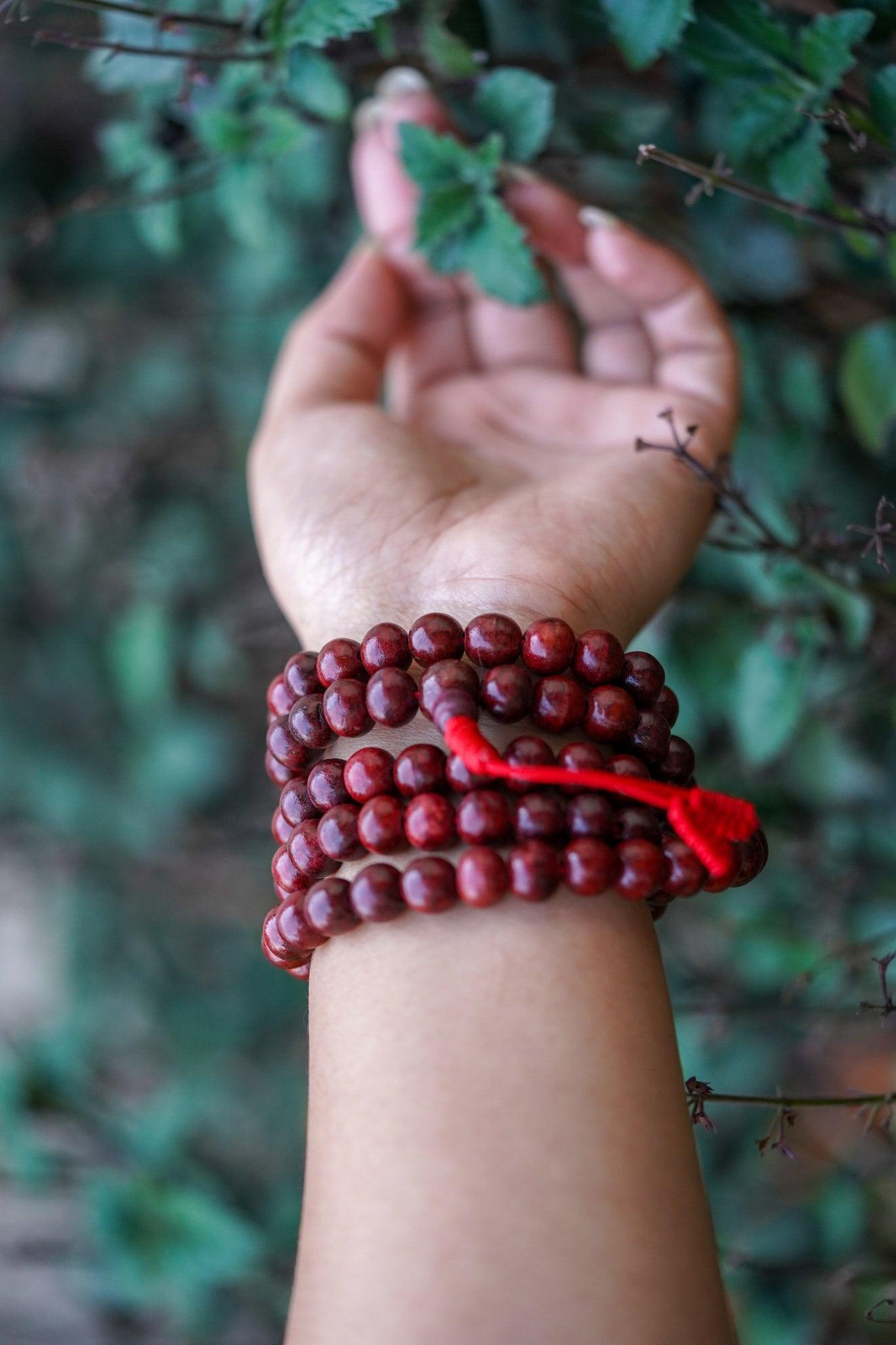 Rosewood Mala being worn around wrist 