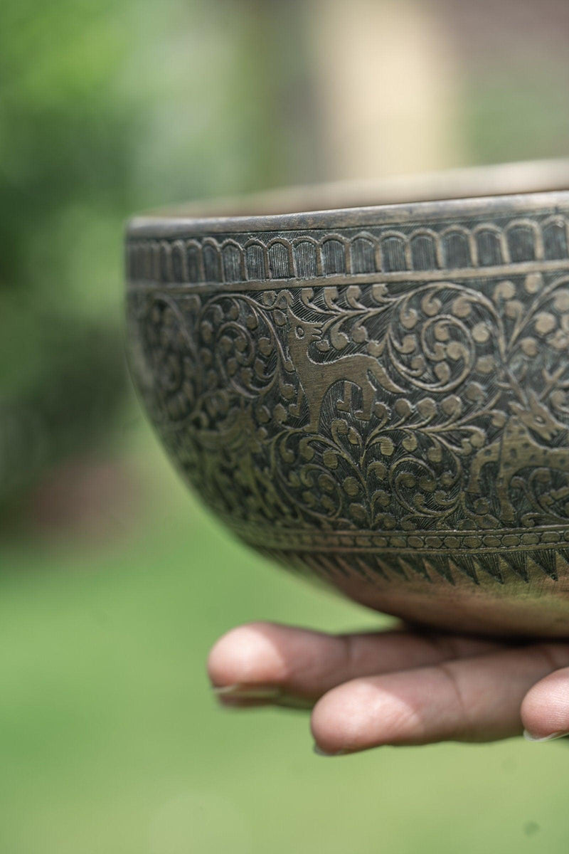 Authentic antique jaambati singing bowl with detail carving of animals from Nepal