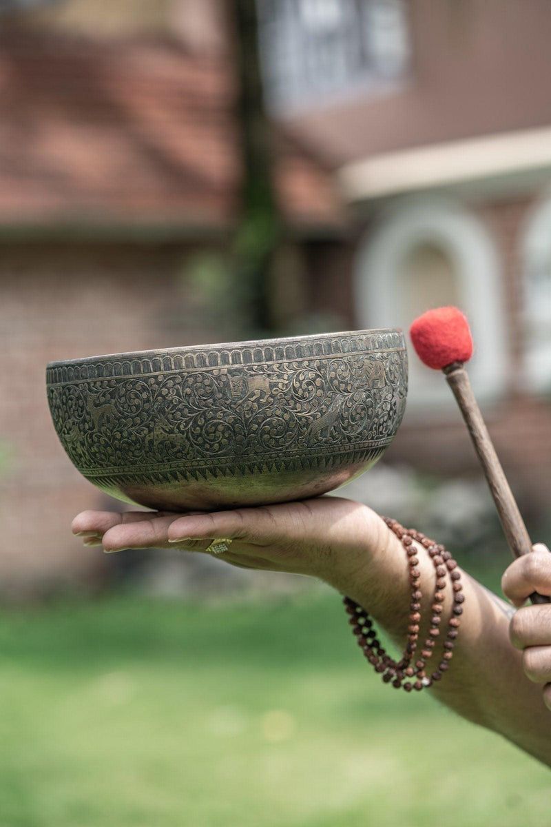 Authentic antique singing bowl with detail carving of animals from Nepal