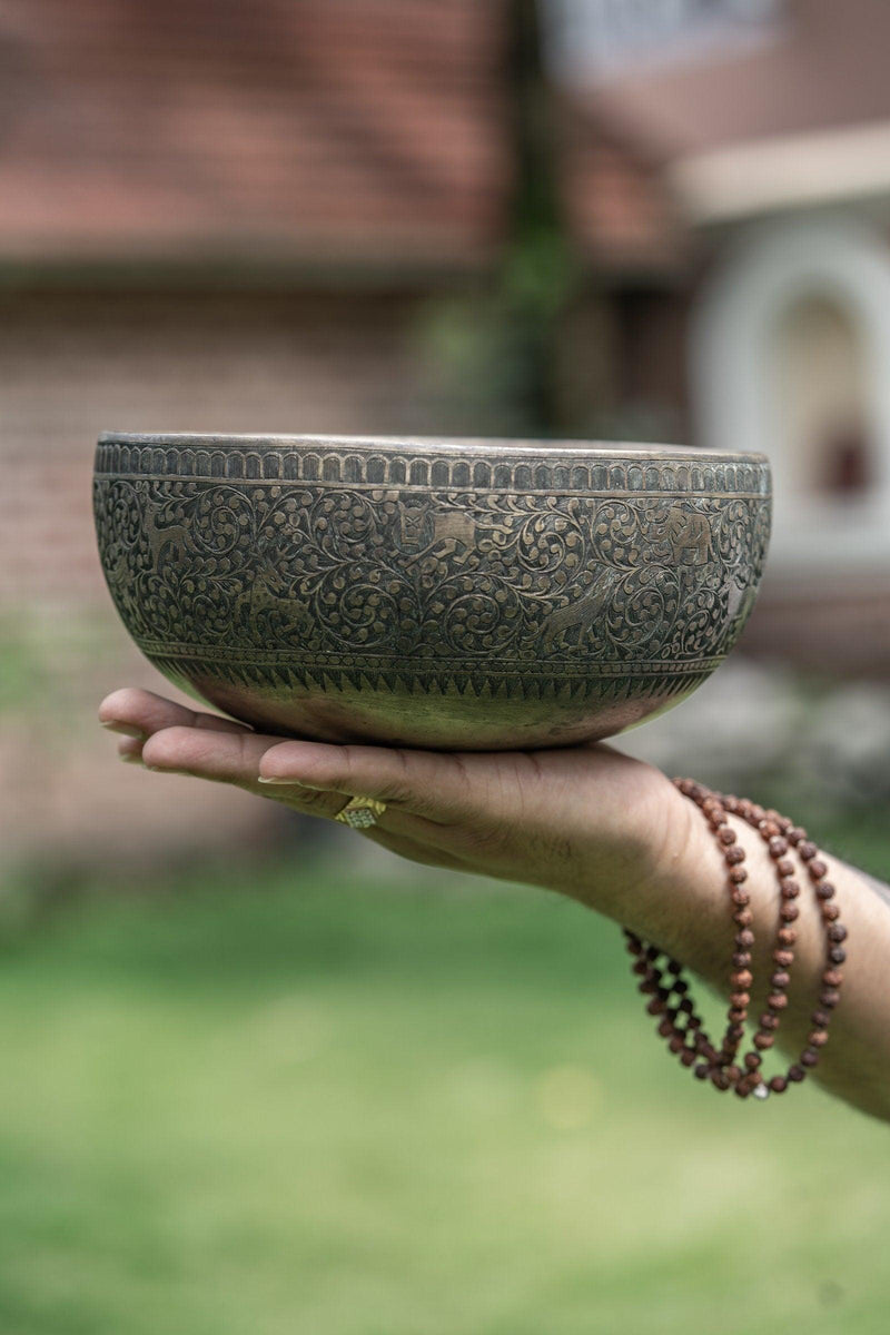 Authentic antique jaambati singing bowl with detail carving of animals from Nepal
