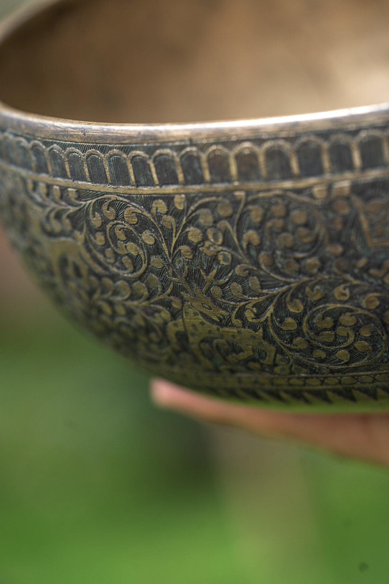 Authentic antique jaambati singing bowl with detail carving of animals from Nepal
