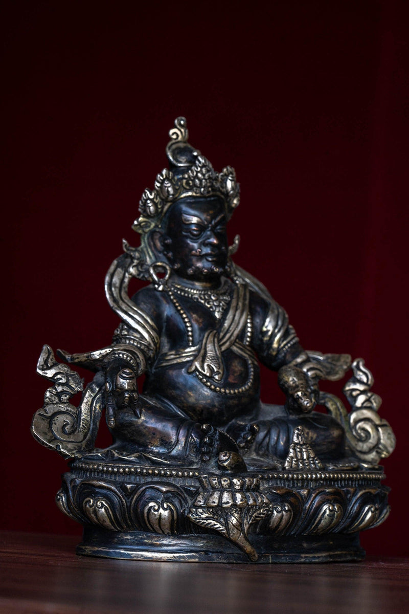 Zambala the god of Fortune in Tibetan Buddhism . Silver Statue of  Zambala - an antique collection Metal craft piece