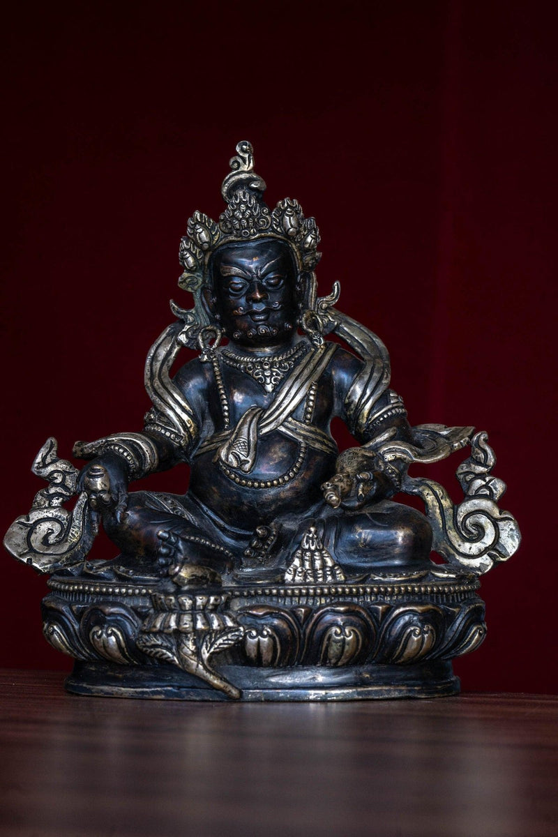 Zambala the god of Fortune in Tibetan Buddhism . Silver Statue of  Zambala - an antique collection Metal craft piece