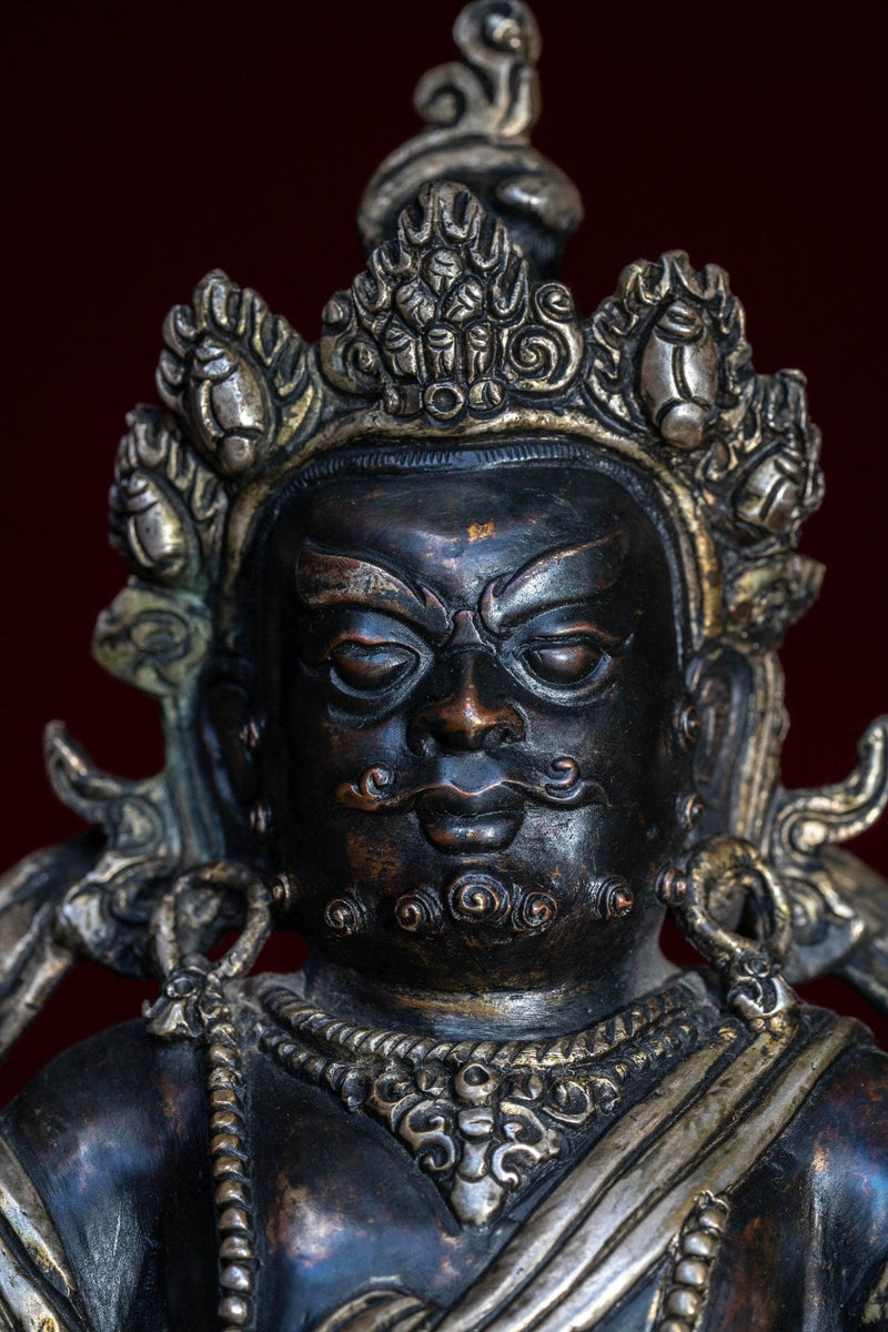 Zambala the god of Fortune in Tibetan Buddhism . Silver Statue of  Zambala - an antique collection Metal craft piece