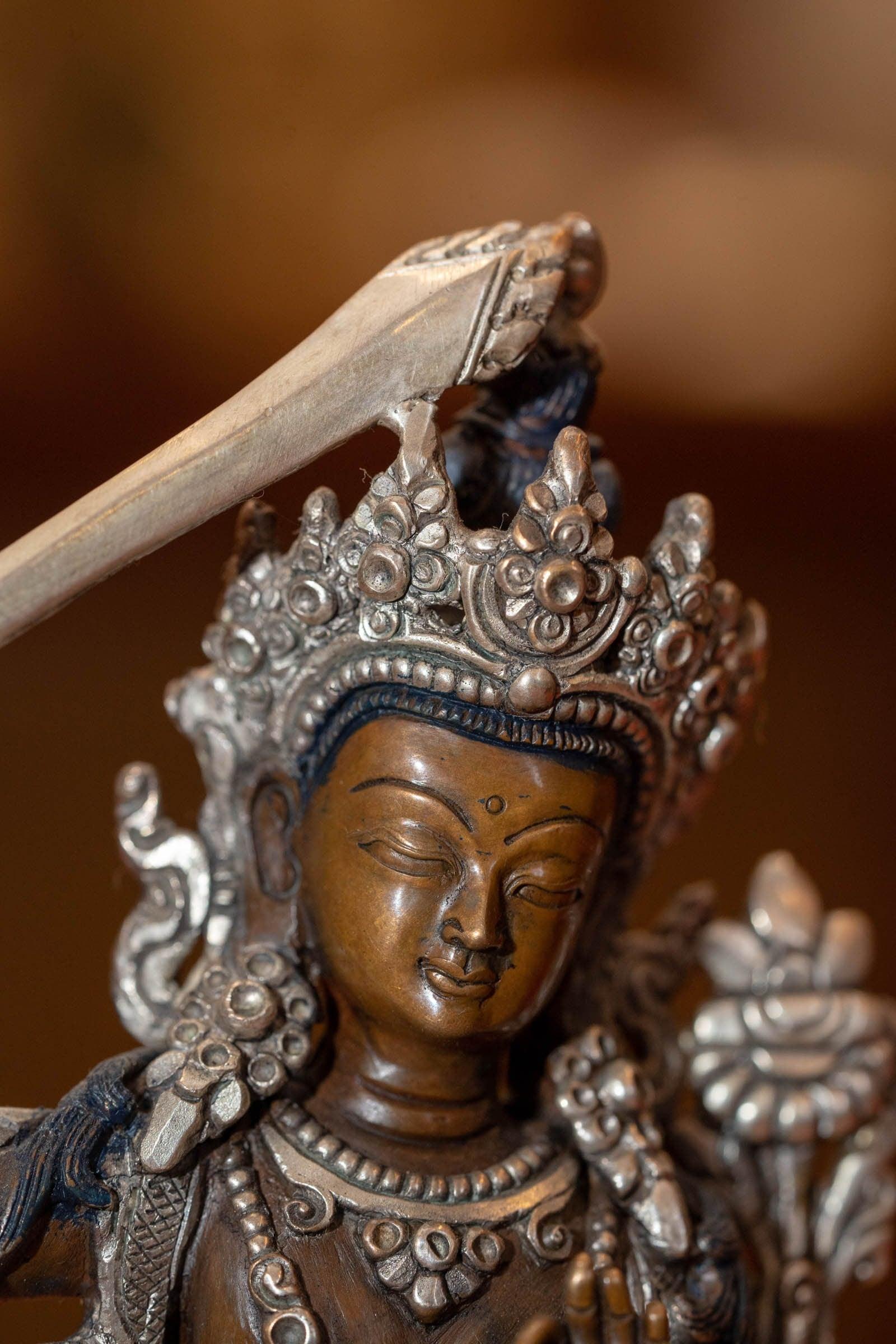  Small copper gilt statue of Manjushri  with silver plated