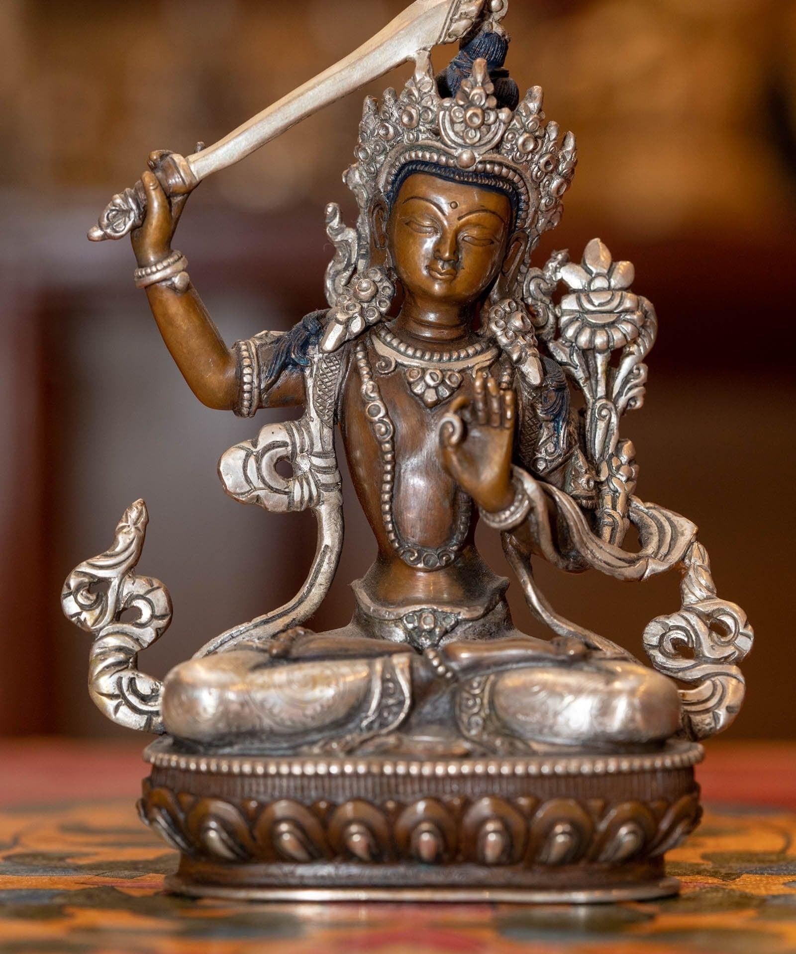  Small copper gilt statue of Manjushri  with silver plated