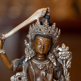  Small copper gilt statue of Manjushri  with silver plated
